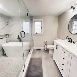 Modern bathroom remodeling with freestanding bathtub and double vanity completed in Connecticut