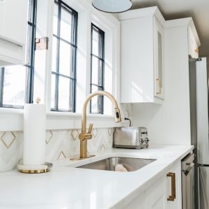 Modern kitchen renovation with large window and farmhouse sink completed in Connecticut