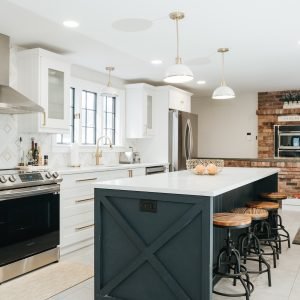Kitchen renovation with dark island cabinets and modern layout in Connecticut