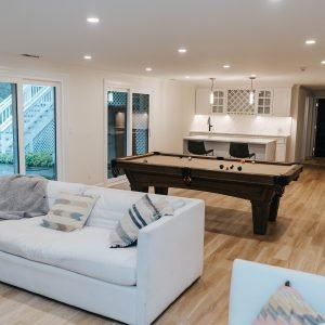 Finished basement living space with entertainment area remodeled by contractor in Connecticut