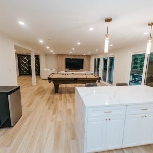 Basement recreation room renovation with open layout and modern flooring in Newington Connecticut
