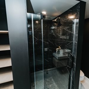 Bathroom renovation with glass shower enclosure and modern tile design in Connecticut